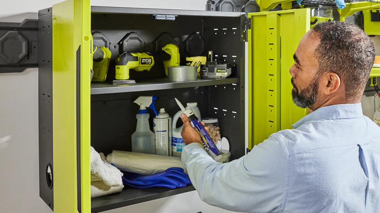 A man opens the Ryobi tool cabinet