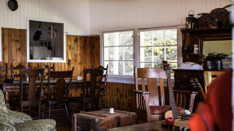 Living area with wood paneled walls and wood furniture