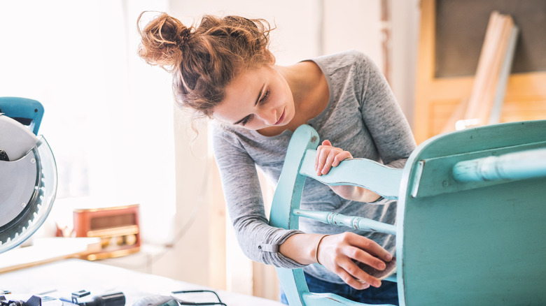 Woman sanding a chair