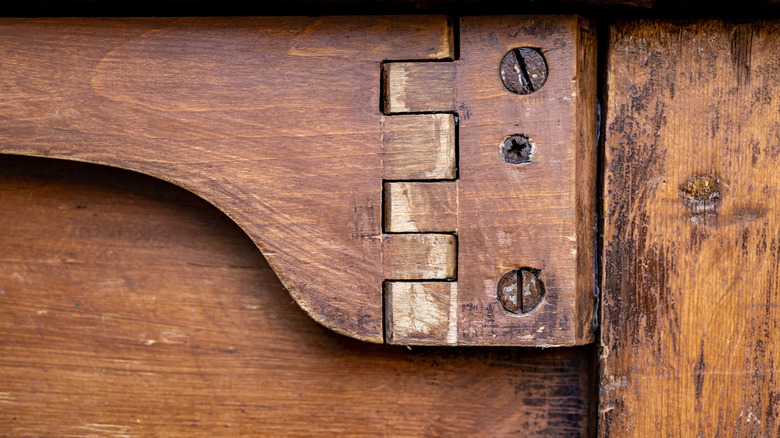 Close up of the screws on an antique wooden table