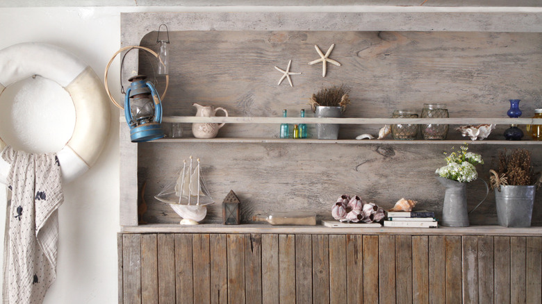 Rustic piece of wood furniture with shelving and nautical-style ornaments