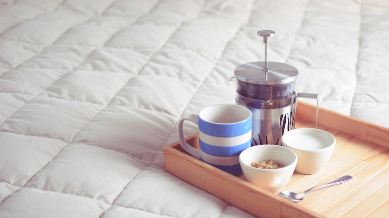 Cornishware mug on tray with French press, milk, and sugar