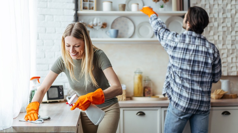 couple cleaning kitchen