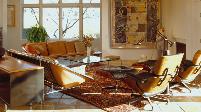 Mid-century modern living room with Eames leather chairs and glass table