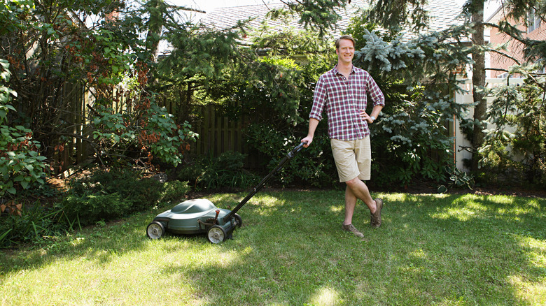man with mower on lawn