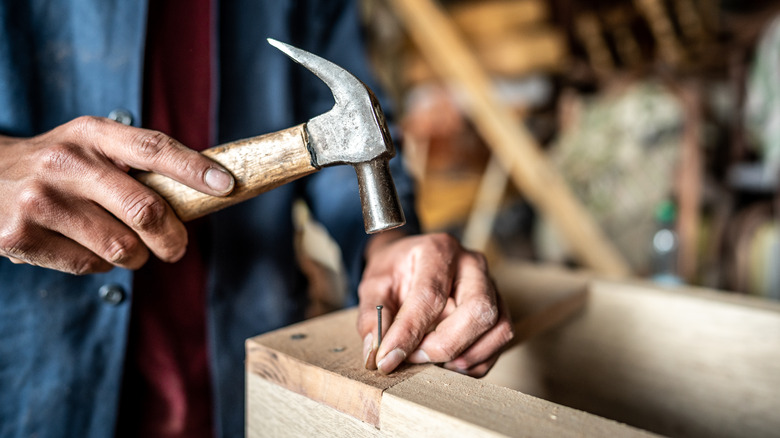 Man hammering nail 