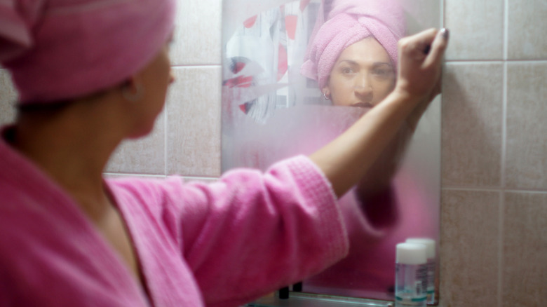 Woman and fogged mirror