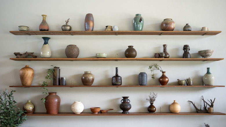 Colorful ceramics on floating wall shelves