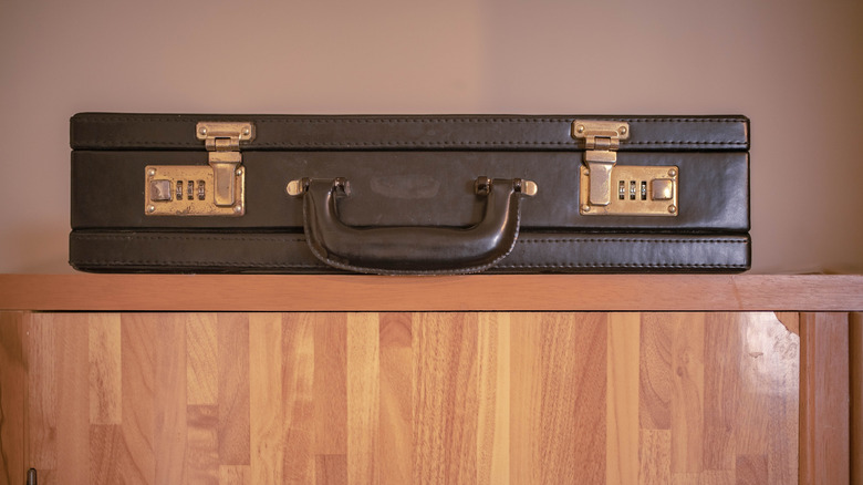 brown briefcase sitting on cabinet