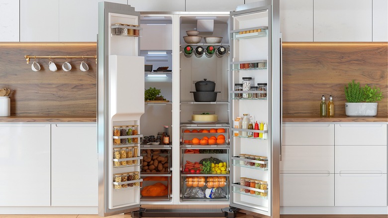 A full, open refrigerator in a modern kitchen