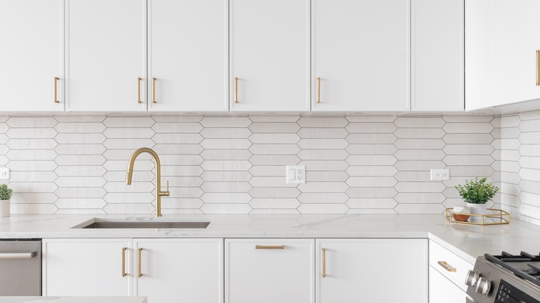 kitchen cabinets with shiny gold hardware