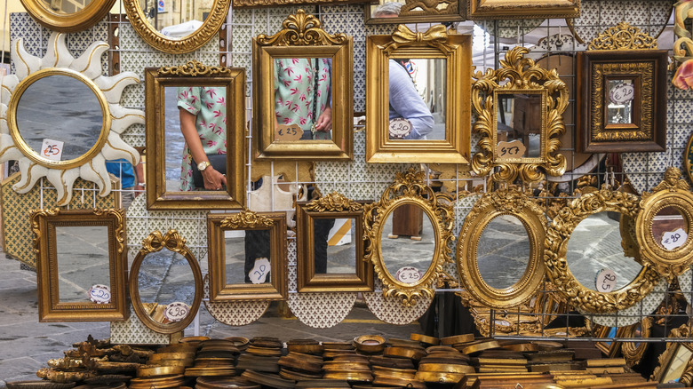 A wall of mirrors in an antique shop
