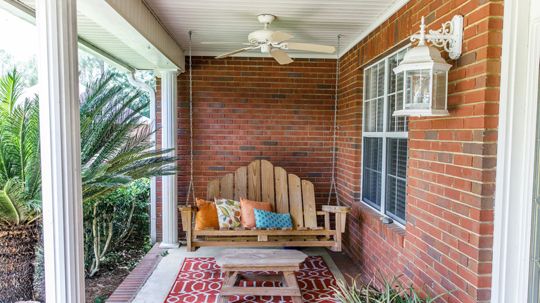 Porch swing against the side of a home