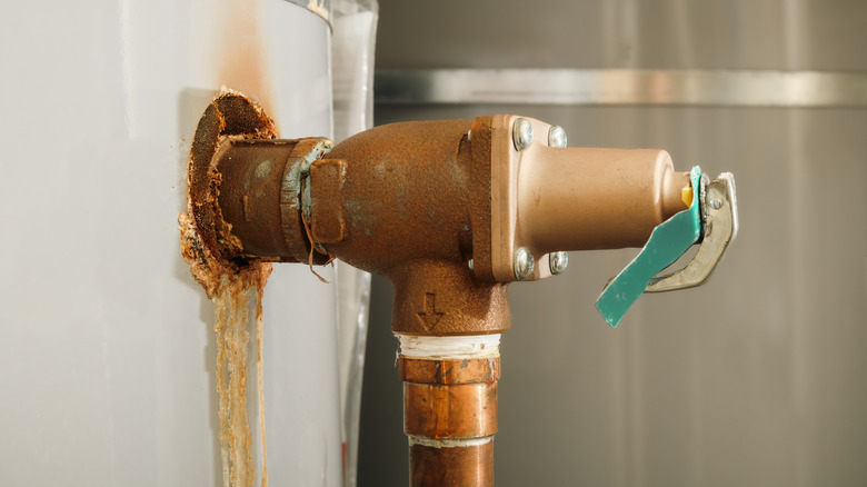 Close up of water heater with rust and hard water build up
