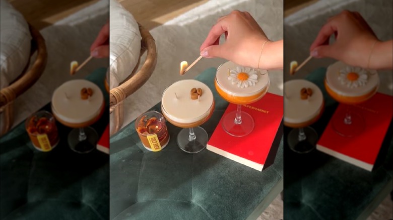 Hand lighting homemade cocktail candles with a match