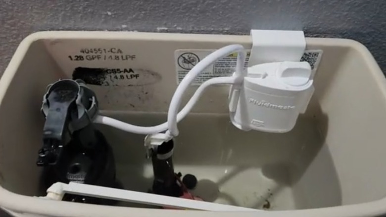 An automatic toilet cleaner installed inside a toilet tank