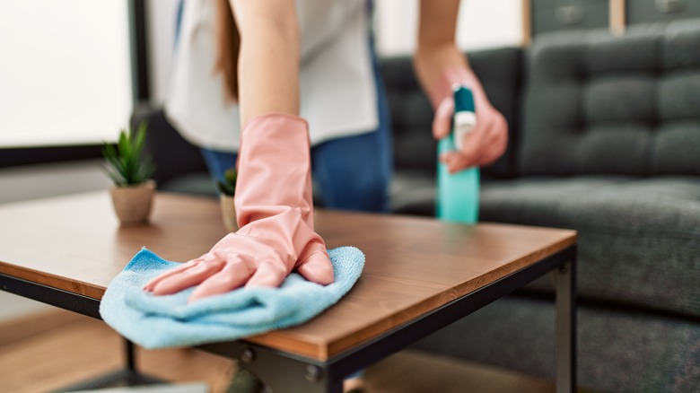 Person cleaning a table