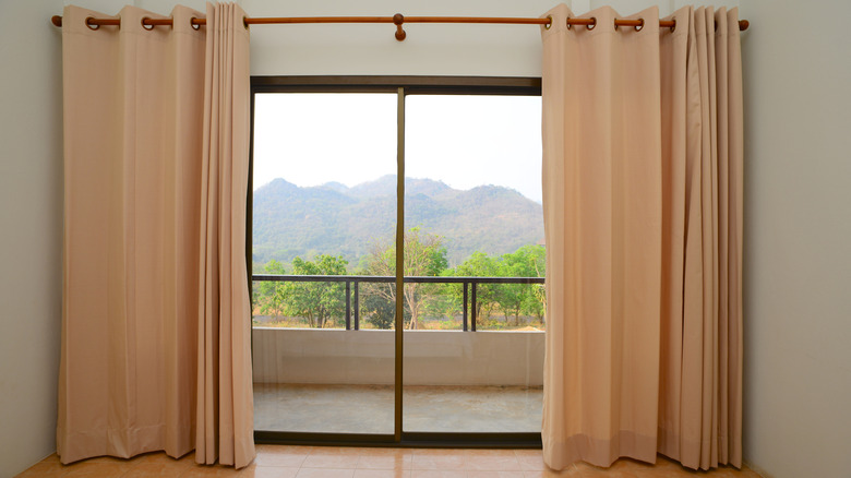sliding glass door with full-length curtains