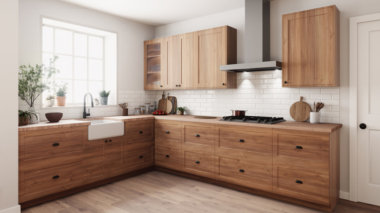 A stylish modern/country-style kitchen featuring wooden cabinets and modern appliances.