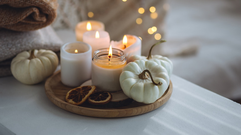 Fall-themed tray with candles and pumpkins