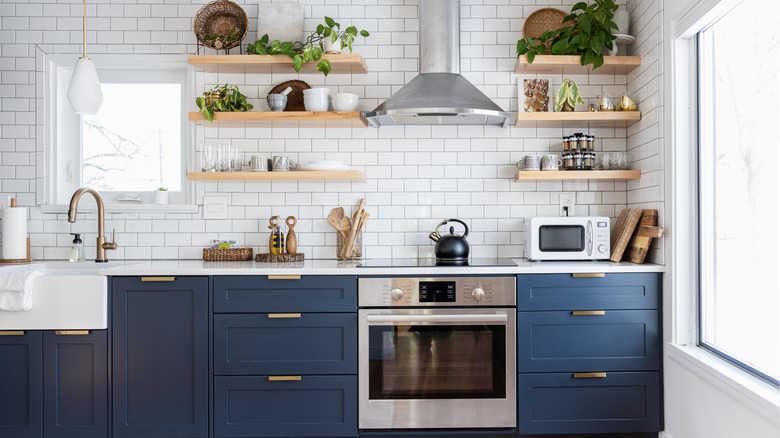 Open shelving kitchen with blue cabinets