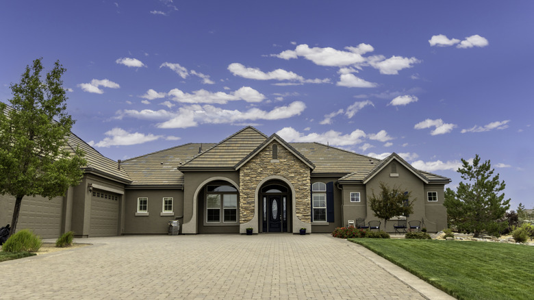 Exterior of a detached home with a driveway in the foreground