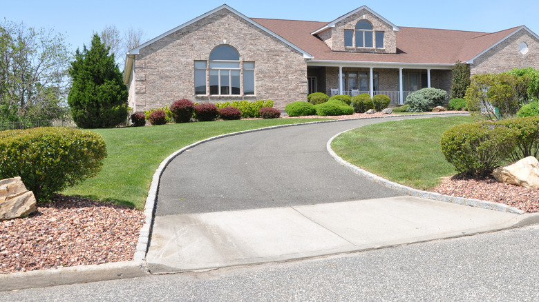 Large suburban home with curbs around driveway