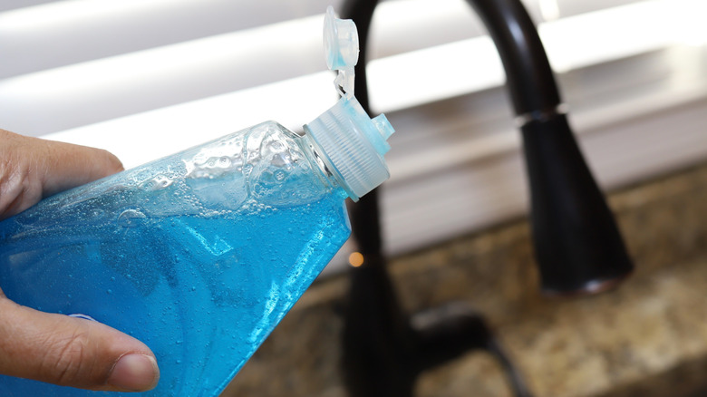 Bottle of blue dish soap with red top