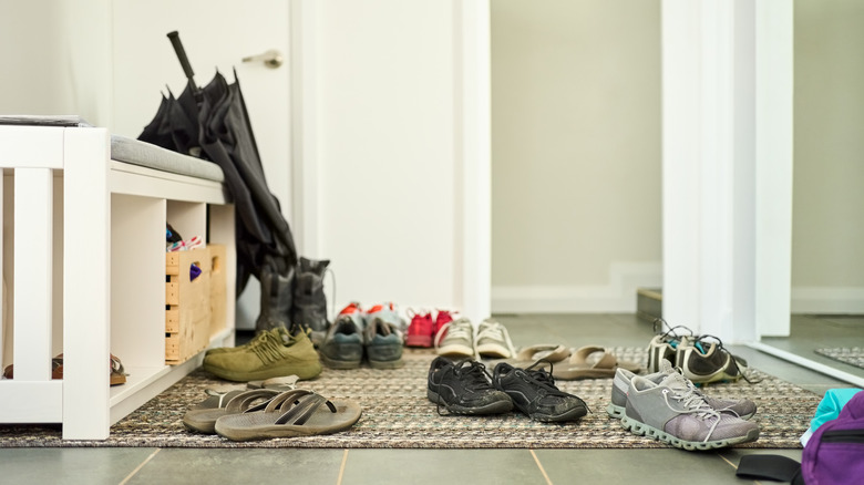 messy entryway bench and shoes