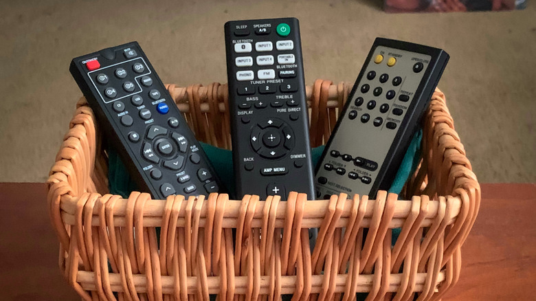 Three remotes housed in a basket