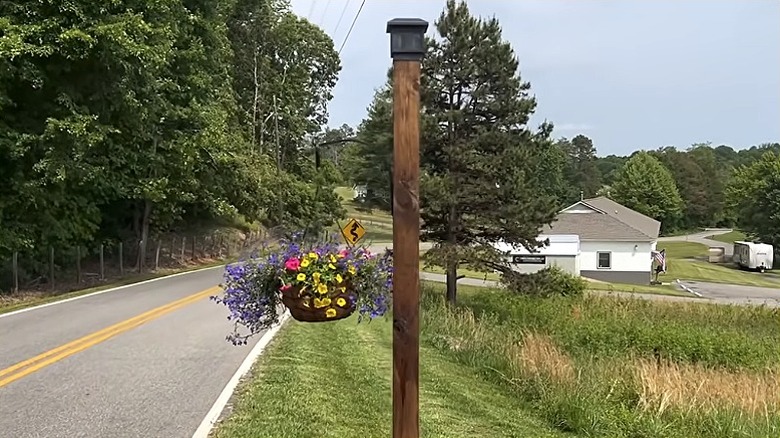 A planter pole with solar light at the entrance of a driveway