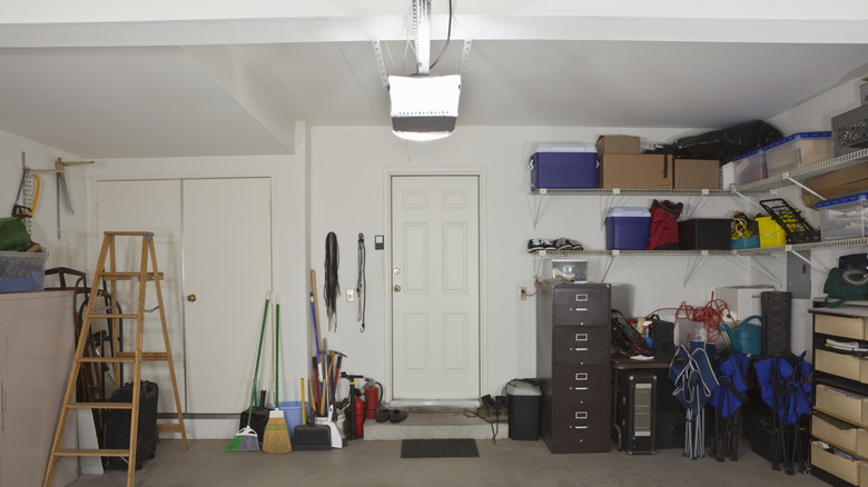 The inside of a garage with storage boxes on shelves