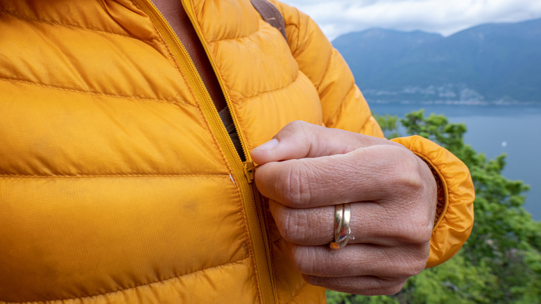 woman zipping up coat