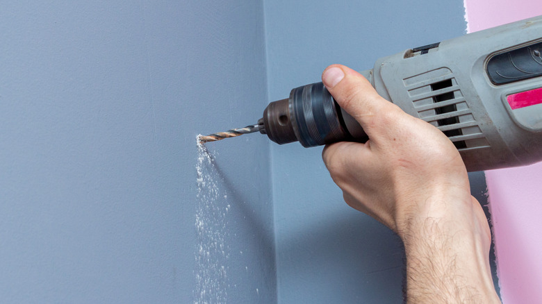 drill dust falling from the wall 