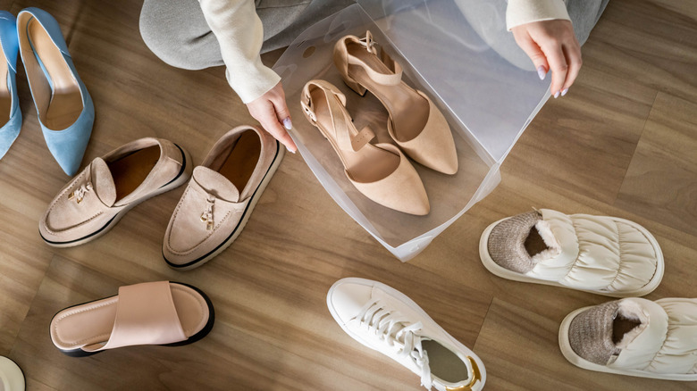 A person organizes their shoes