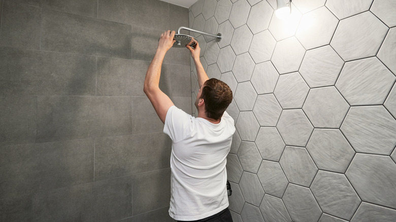 Man installs a showerhead