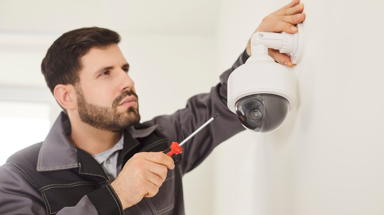 Man installing video camera