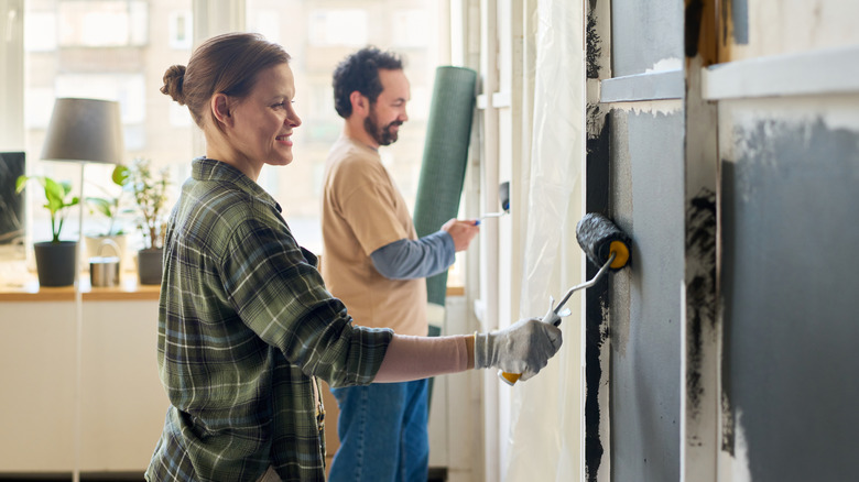 two people working on home painting project