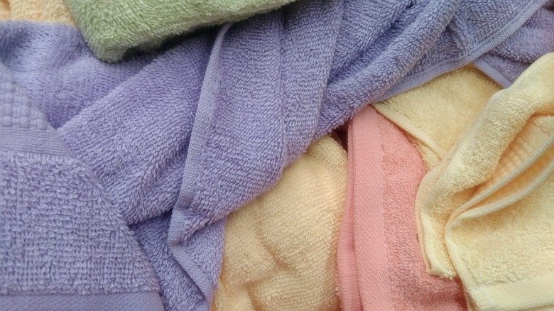 Messy pile of pastel colored bath towels