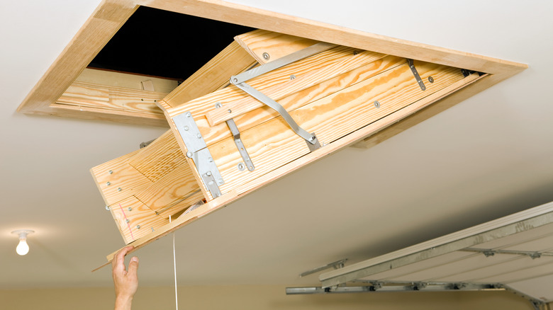 Attic door being opened by string