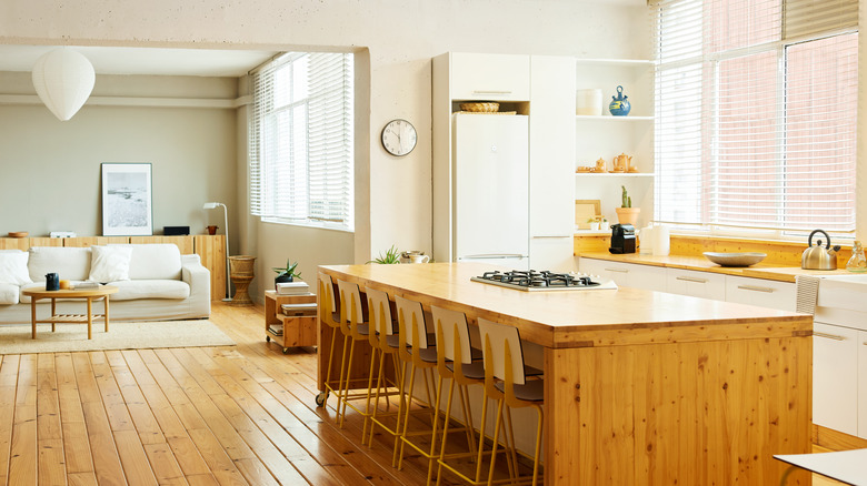 Kitchen island with built-in cooktop and bar stools