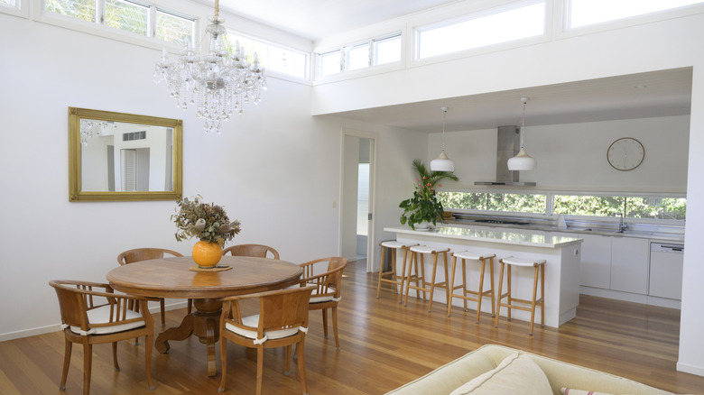A kitchen and dining area with a crystal chandelier