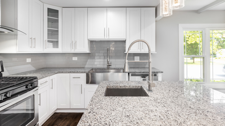 white kitchen with granite countertops