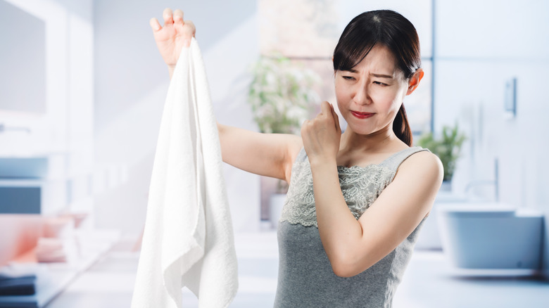 Woman holding a musty towel
