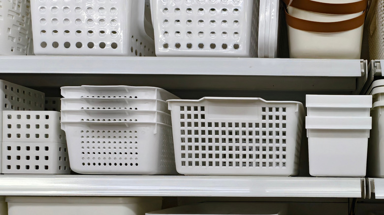 Shelves with white plastic storage baskets.