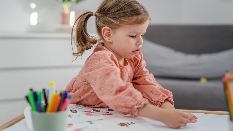 Child playing with stickers