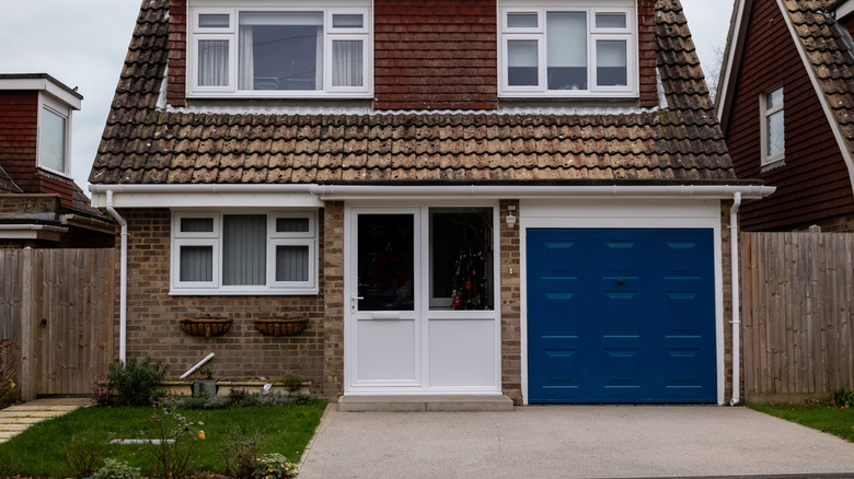 an attractive home with a sloped resin driveway