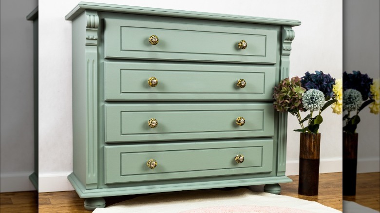 green dresser in white room
