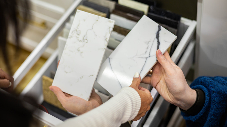 Someone holding marble tile samples