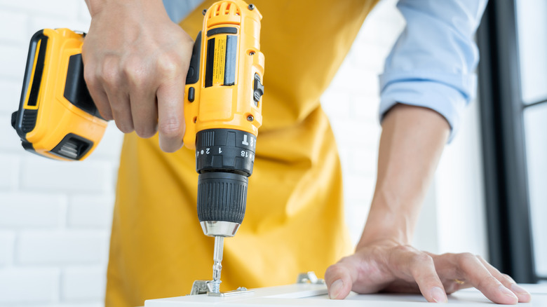 Person using a cordless drill